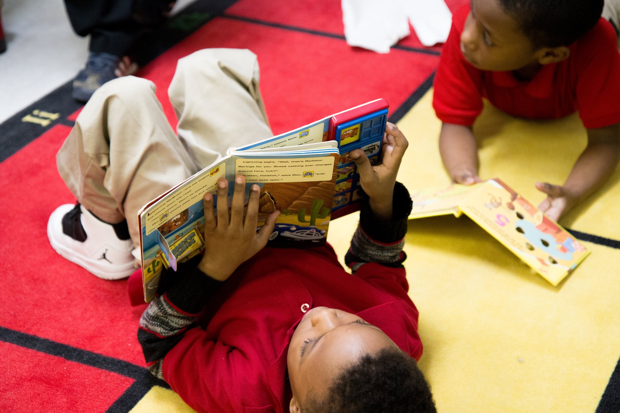 Scholar Reading a book laying on the floor. Scholar Reading a book laying on the floor.
